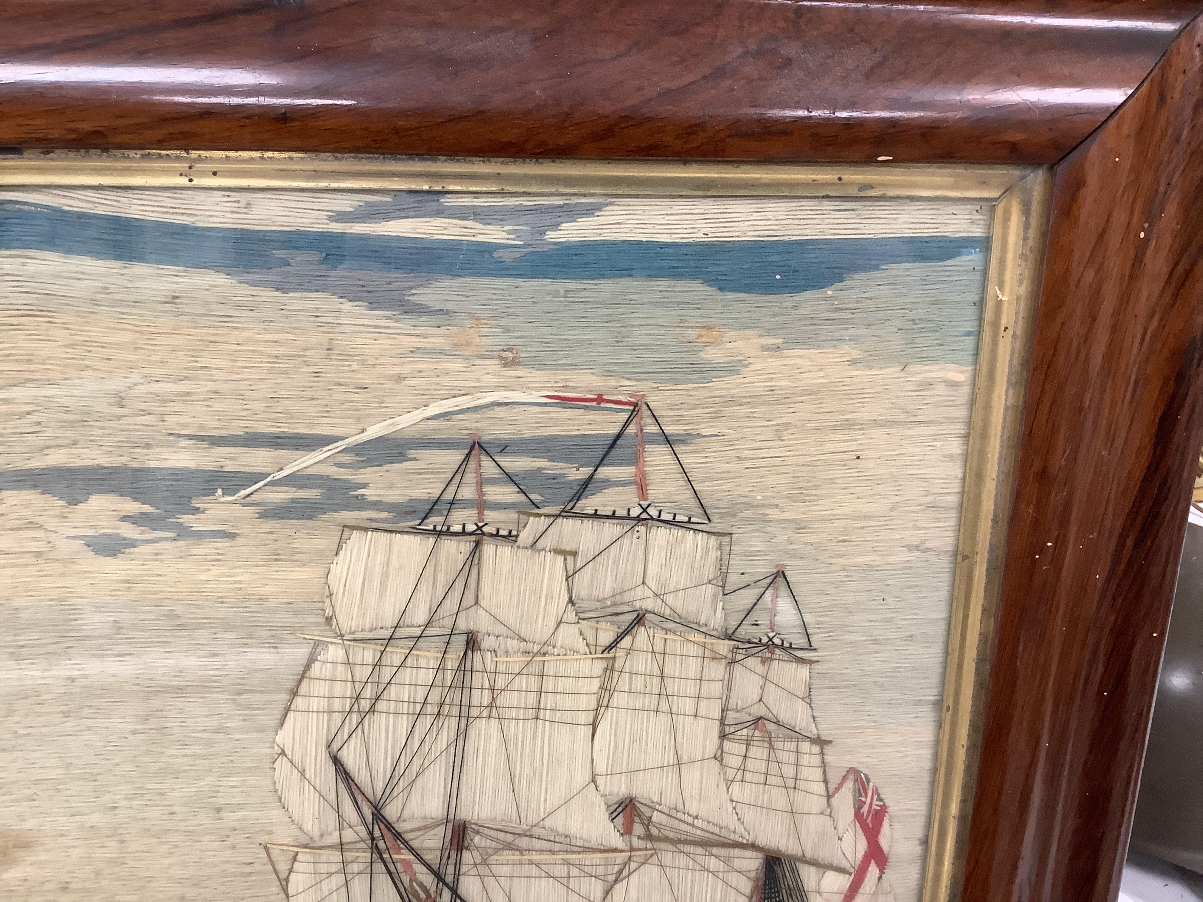 A large 19th century folk art ‘sailors woolie’ embroidery, of a naval steam ship and a frigate, both flying the Royal Navy ensign. 74cm x 39cm.